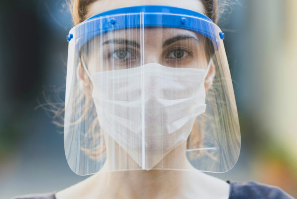 woman with face mask and face shield on