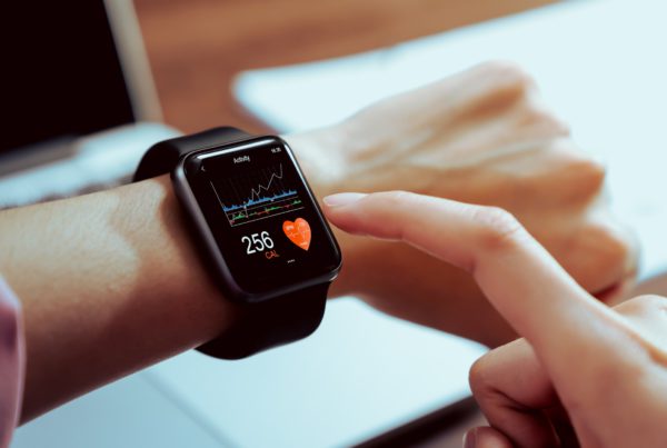 person with apple watch on wrist looks at heart activity