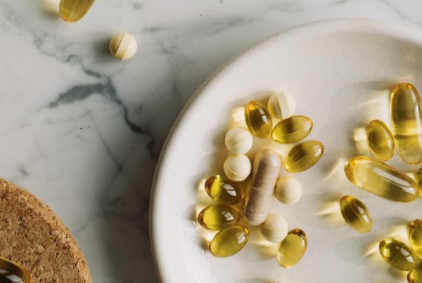 yellow and white pills and supplements on a white plate