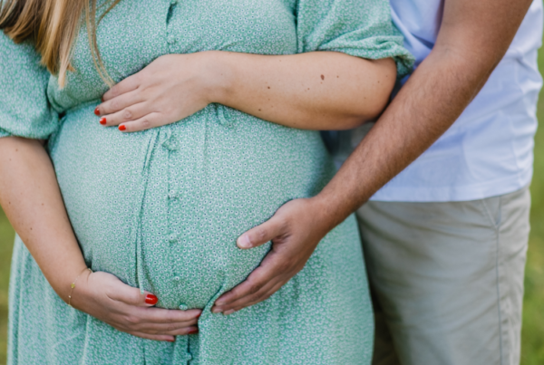 couple holding woman's pregnant stomach